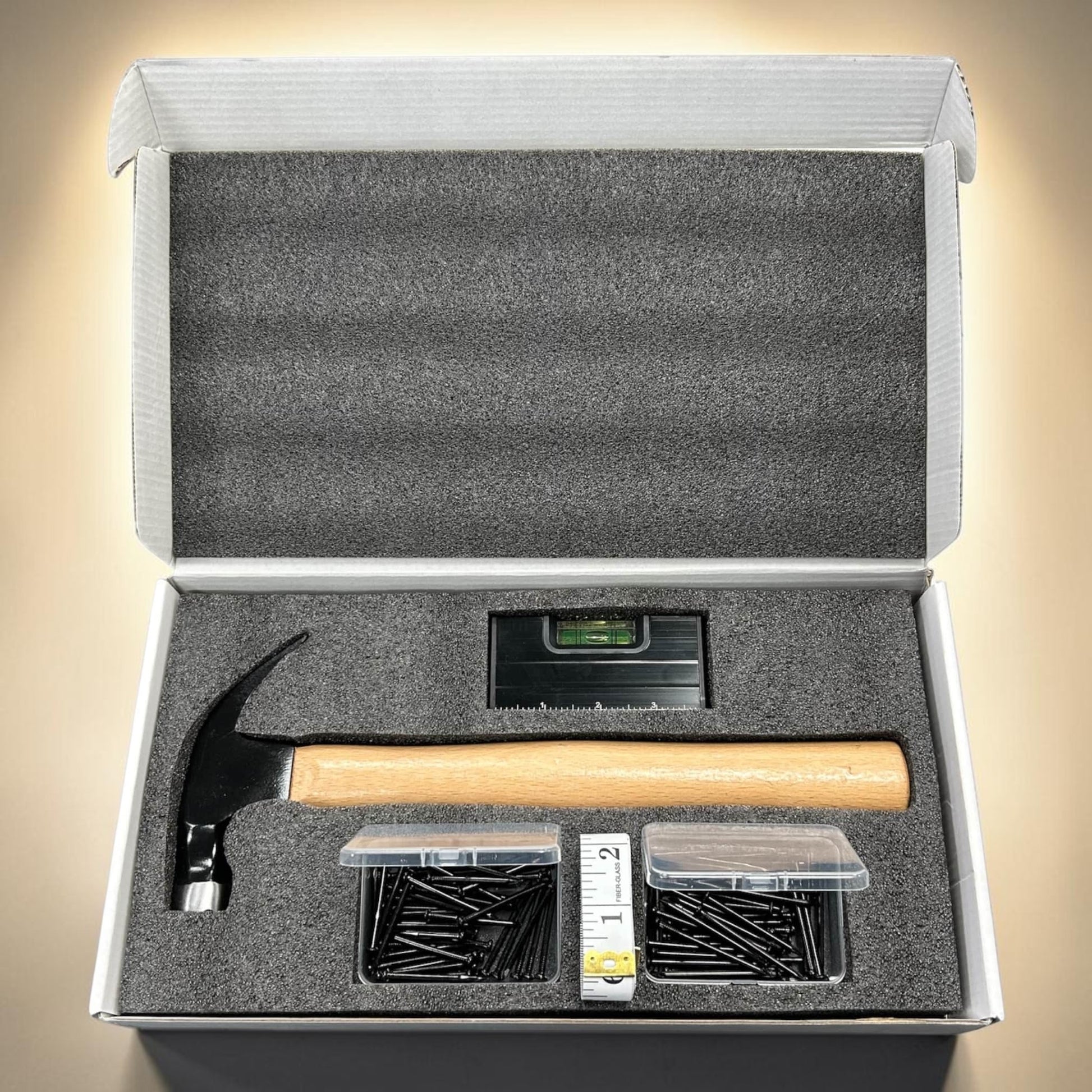 Open tool kit with hammer, nails, and level ideal gift for him
